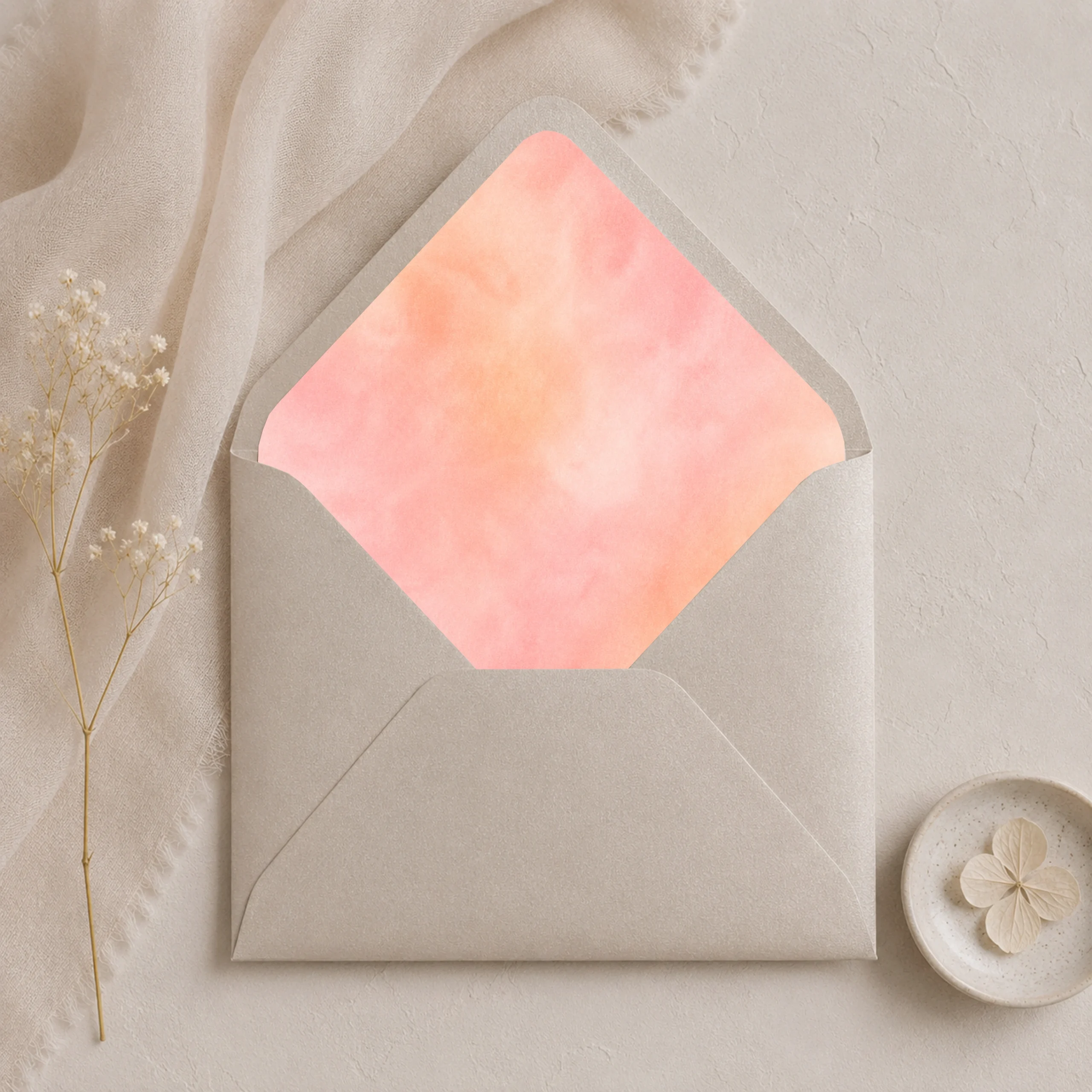 Metallic Sand envelope with Apricot Blush watercolor envelope liner in soft peach and blush tones, styled for elegant wedding invitations.