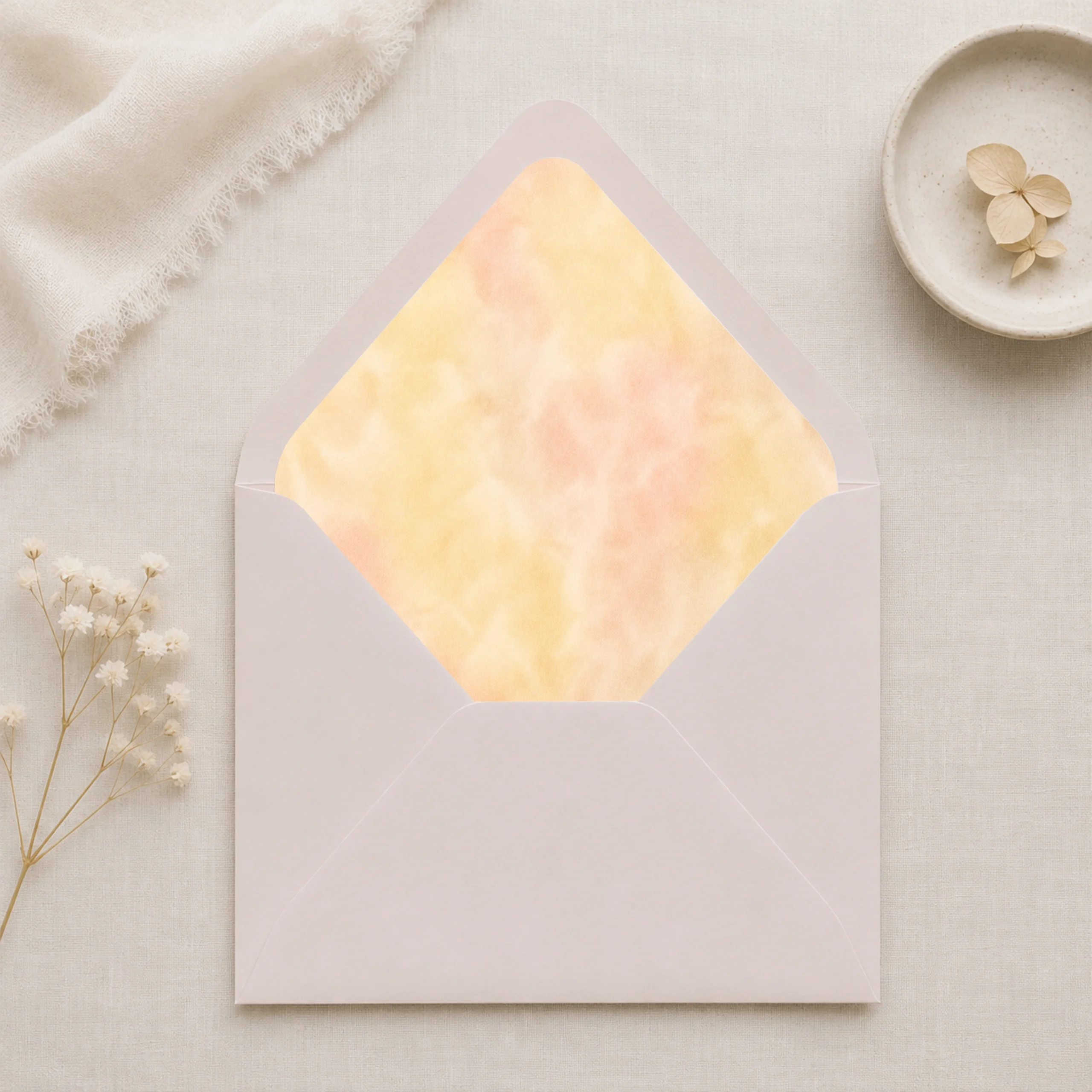 Butter Blush Envelope Liner Template displayed inside a Taupe envelope with soft butter yellow and blush watercolor design for elegant wedding invitations.